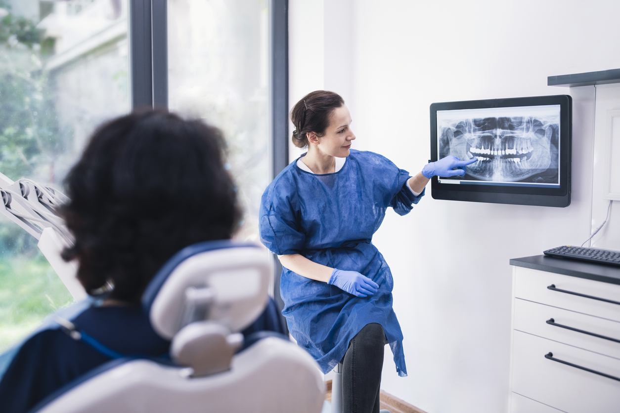 dentist-showing-patient-signs-of-oral-cancer